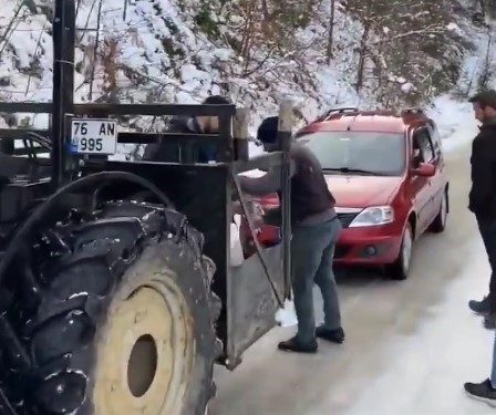 Buzlu yolda rampayı çıkamayan araçlar traktörle çekildi